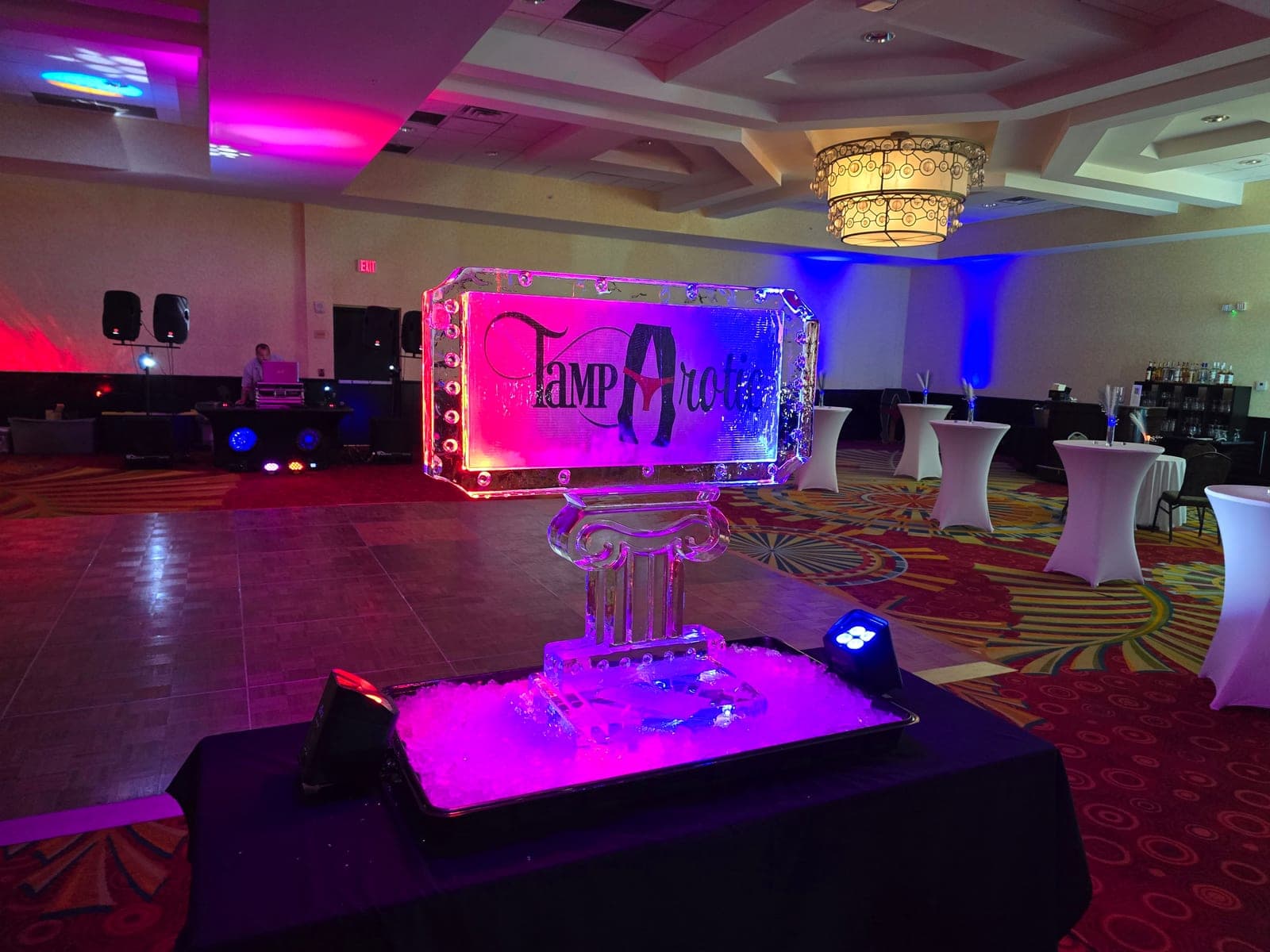 An ice sculpture centerpiece glowing under club lighting at a TampArotic night